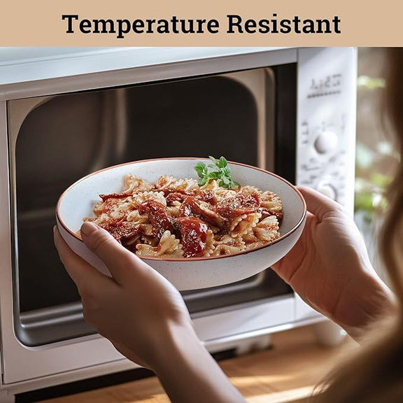 Person holding a bowl of food in front of a microwave with 'Temperature Resistant' text above.