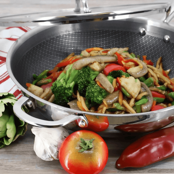 Stir-fry dish with vegetables in a wok on a wooden surface