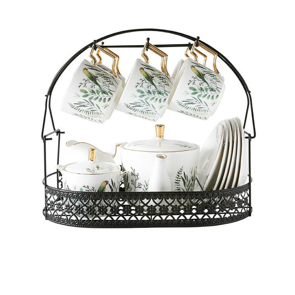 Tea set with cups, teapot, and sugar bowl in a decorative stand on a white background