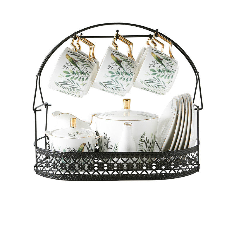 Tea set with cups, teapot, and sugar bowl in a decorative stand on a white background