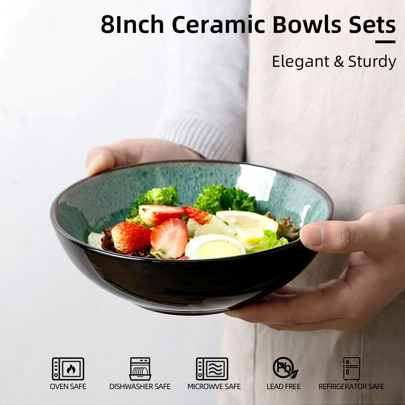 Person holding a 8-inch ceramic bowl filled with salad on a white background