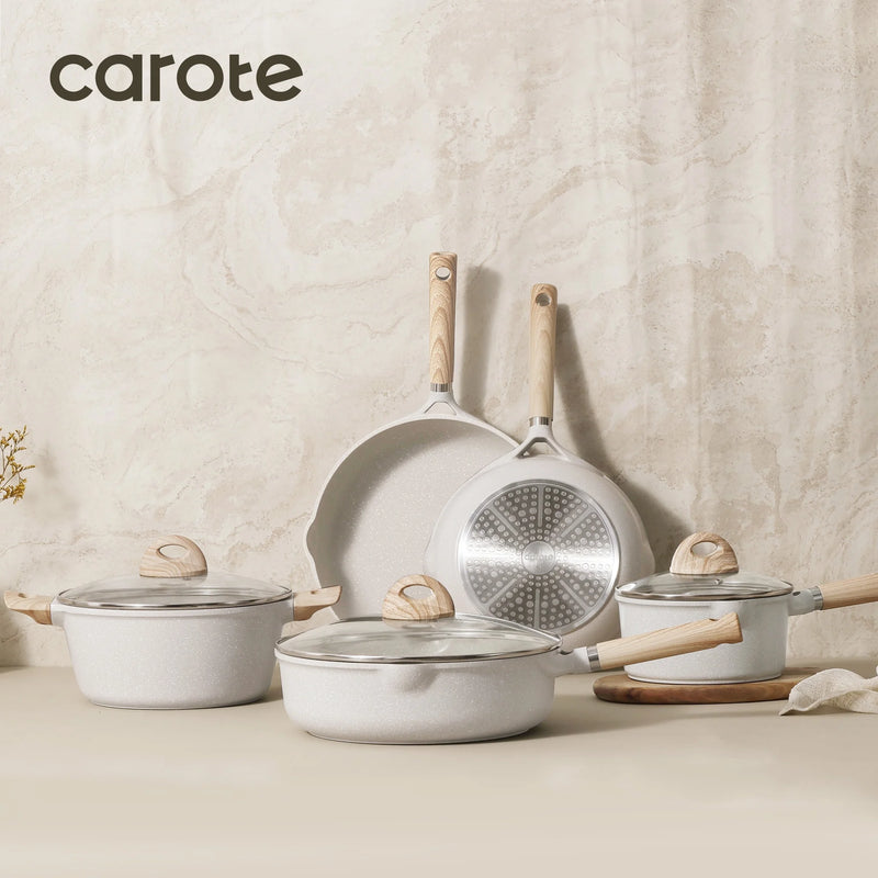 Set of cookware with wooden handles on a neutral background, featuring the brand 'carote'.