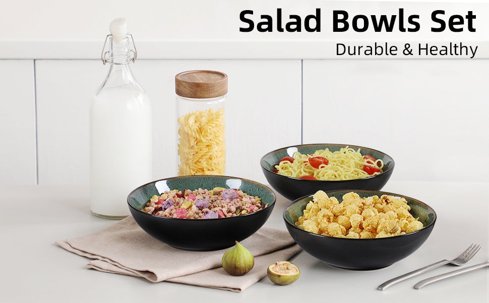 Set of salad bowls with various contents on a white surface, featuring a glass jar and pasta.