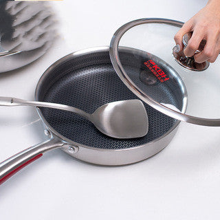 Stainless steel frying pan with lid on a white background