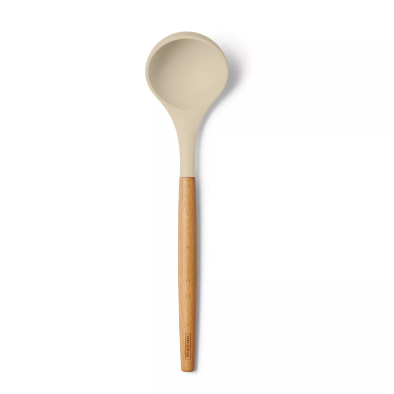Beige silicone spoon with a bamboo handle on a white background