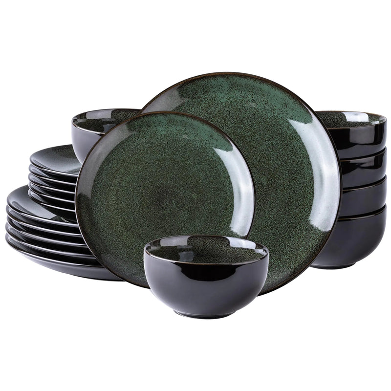Set of green and black ceramic dinnerware on a white background