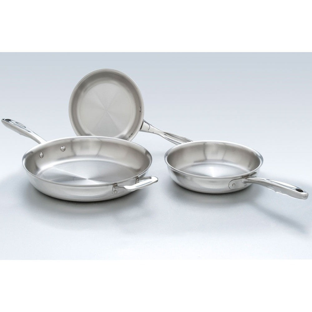 Set of stainless steel frying pans on a light gray background