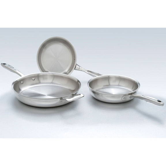 Set of stainless steel frying pans on a light gray background