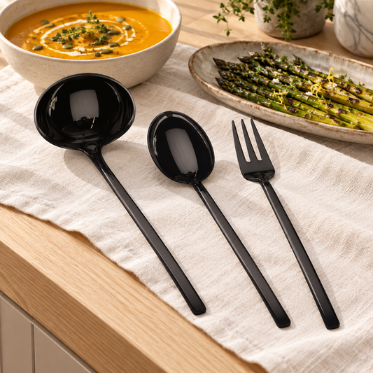 Mepra Due Oro Nero three-piece black serving set beside pumpkin soup