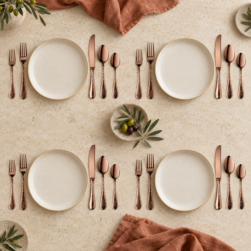 Mepra Epoque Bronze 20-piece hammered flatware set arranged for four bright place settings