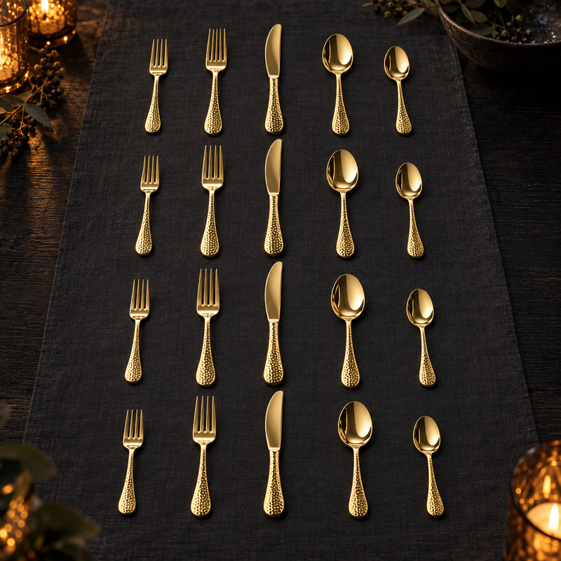 Mepra Epoque Oro 20-piece hammered gold flatware displayed in four elegant evening rows