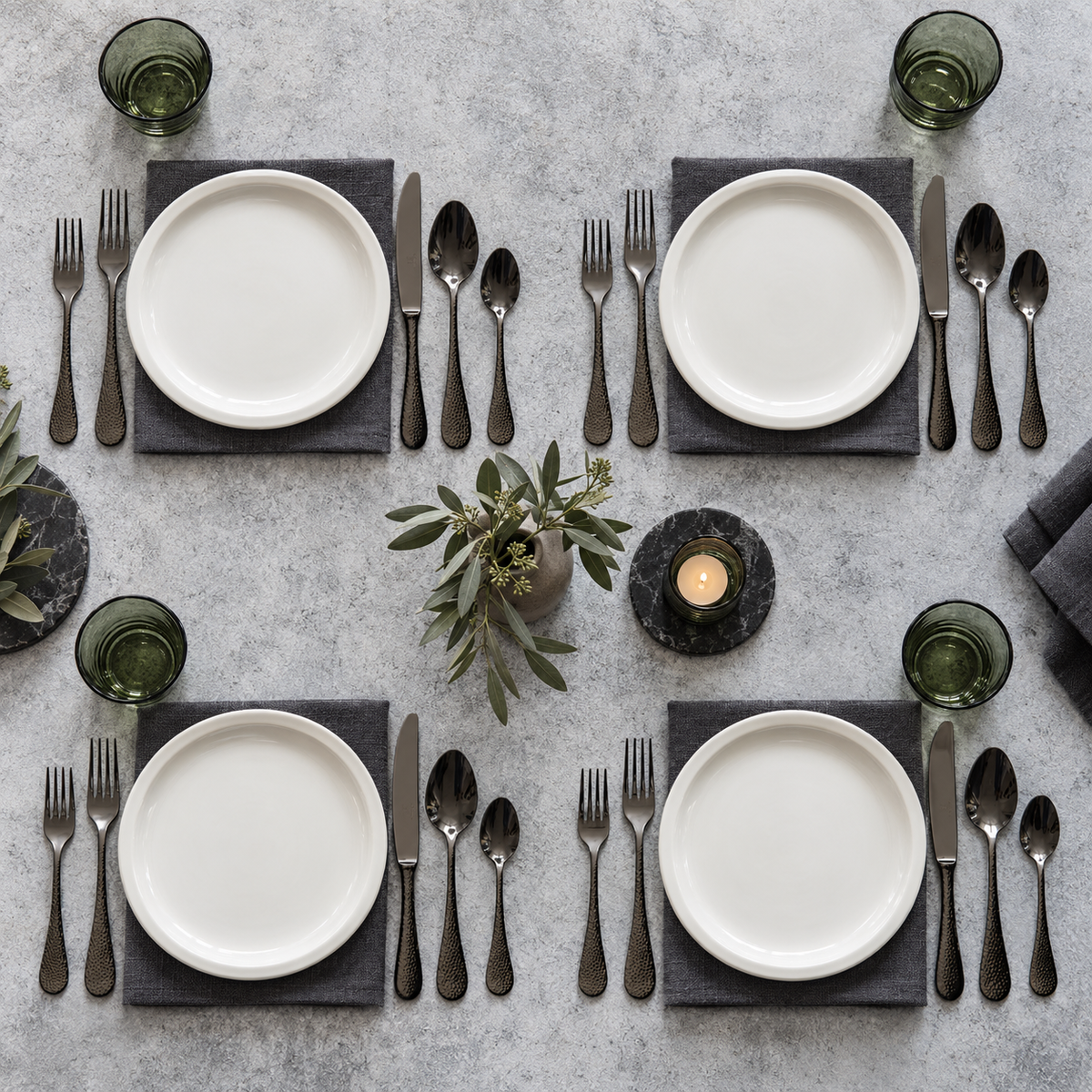 Mepra Epoque Oro Nero 20-piece hammered dark flatware arranged for four modern place settings