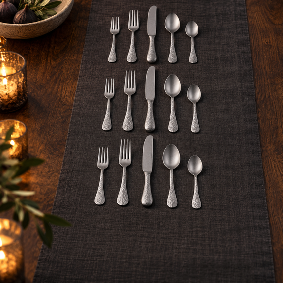 Mepra Epoque Pewter 20-piece hammered flatware set in an elegant evening display
