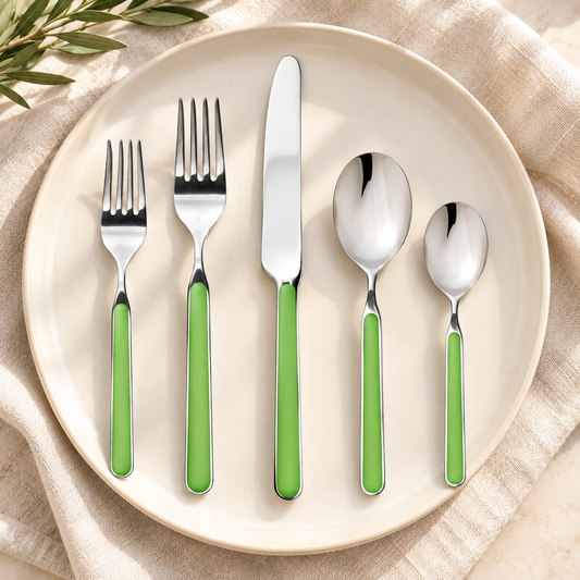 Mepra Fantasia Apple Green five-piece flatware place setting on cream linen