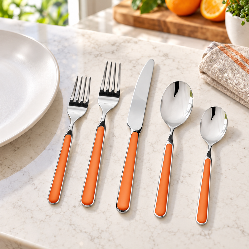Mepra Fantasia Carrot five-piece flatware on a bright kitchen counter