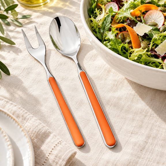 Mepra Fantasia Carrot two-piece salad servers with orange handles on ivory linen