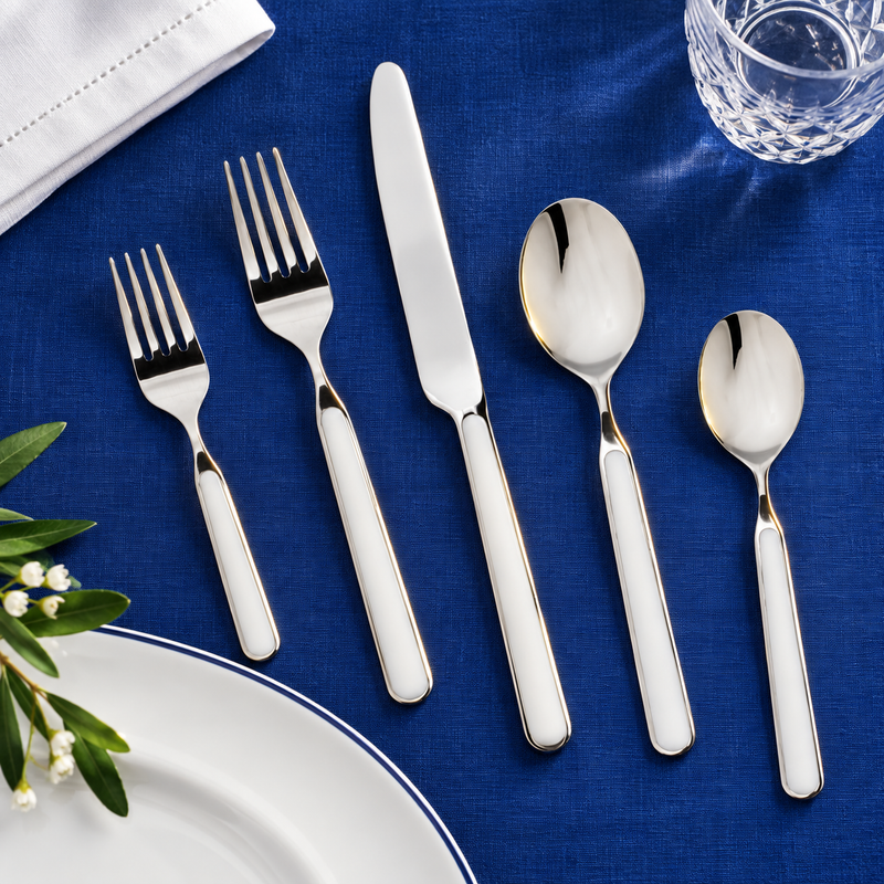 Mepra Fantasia China five-piece flatware on cobalt blue linen
