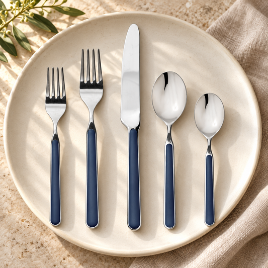 Mepra Fantasia Cobalt five-piece flatware on warm stone and ivory plate