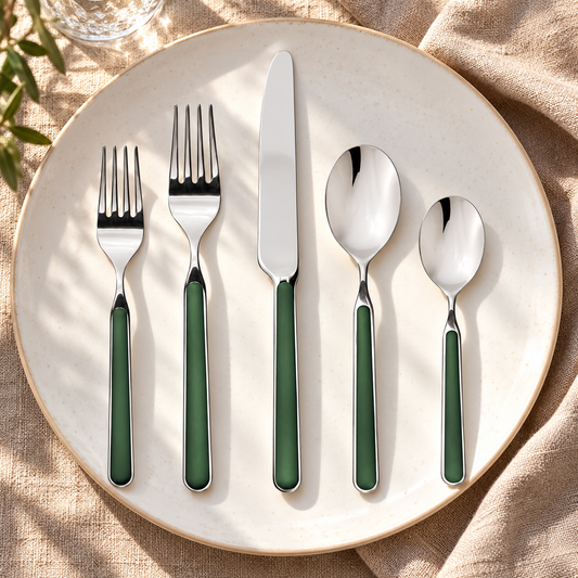 Mepra Fantasia Forest Green five-piece flatware on ivory plate and warm linen