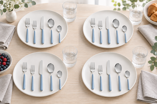 Mepra Fantasia Ice Oro Light Blue 20-piece flatware arranged as four airy Scandinavian place settings