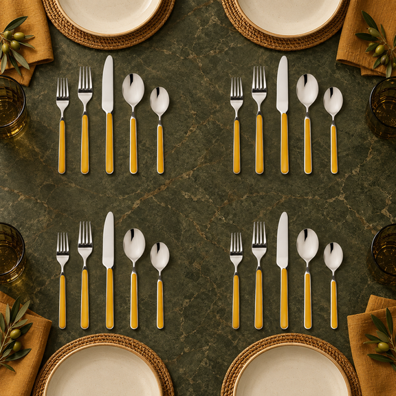 Mepra Fantasia Ice Oro Mustard 20-piece flatware displayed as four sophisticated modern place settings