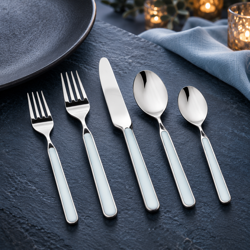 Mepra Fantasia Light Blue five-piece flatware on dark slate blue stone