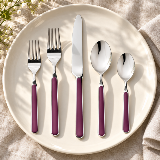 Mepra Fantasia Light Mauve five-piece flatware on an ivory plate and linen