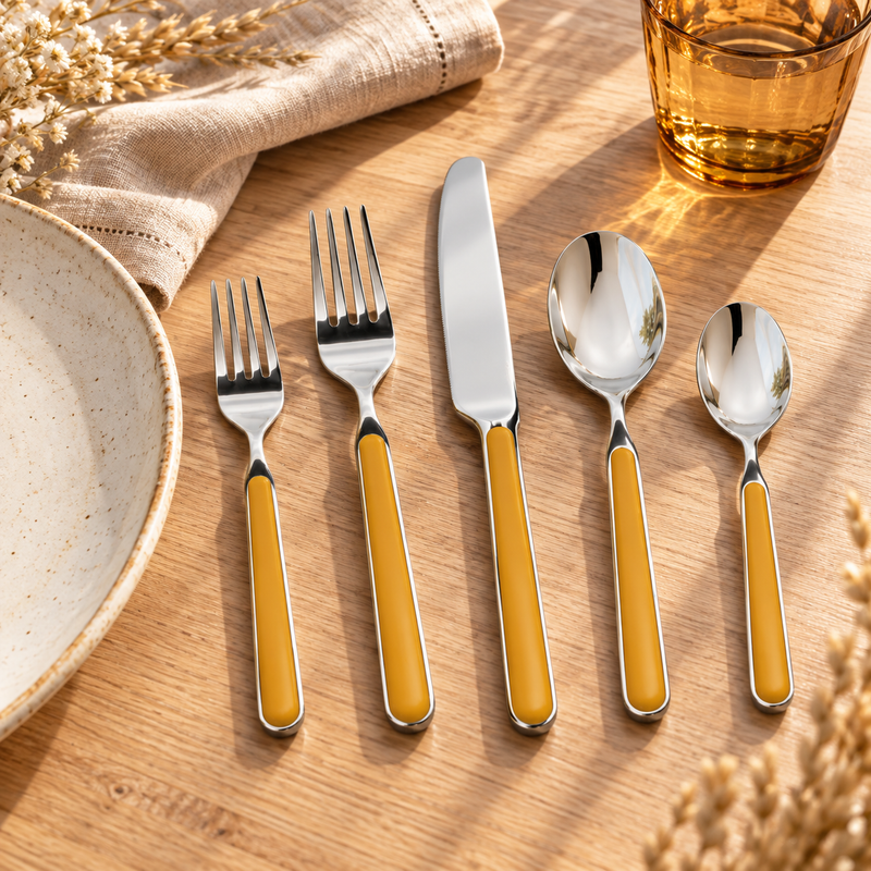 Mepra Fantasia Mustard five-piece flatware on sunlit pale oak