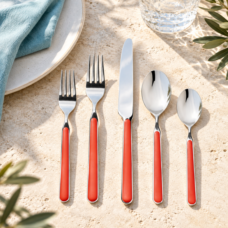 Mepra Fantasia New Coral five-piece flatware in a Mediterranean setting