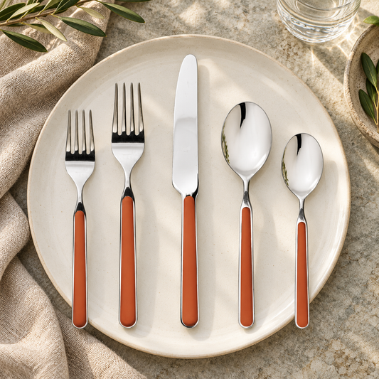 Mepra Fantasia Rust five-piece flatware on an ivory plate with linen