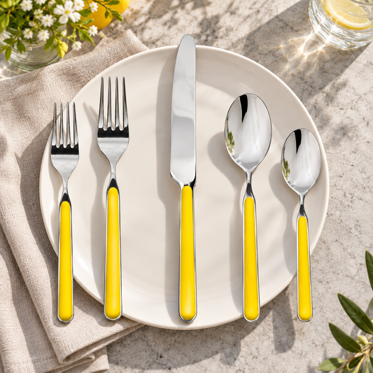 Mepra Fantasia Sunflower five-piece flatware on an ivory plate with linen