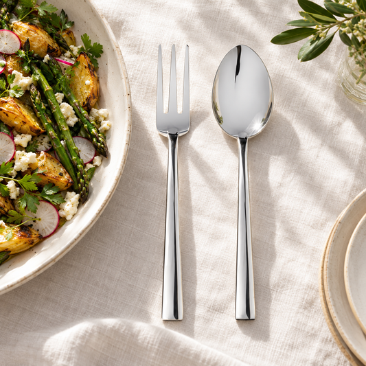 Mepra Levantina three-tine serving fork and serving spoon on linen