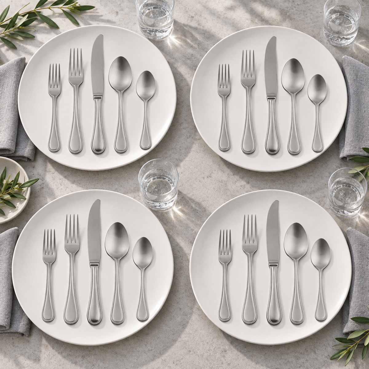 Mepra Perla Ice 20-piece brushed silver flatware arranged as four modern daylight place settings