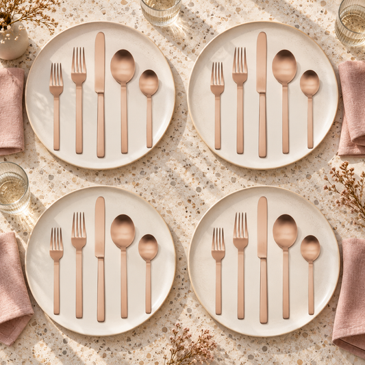 Mepra Stile Ice Bronzo 20-piece flatware arranged as four warm daylight place settings