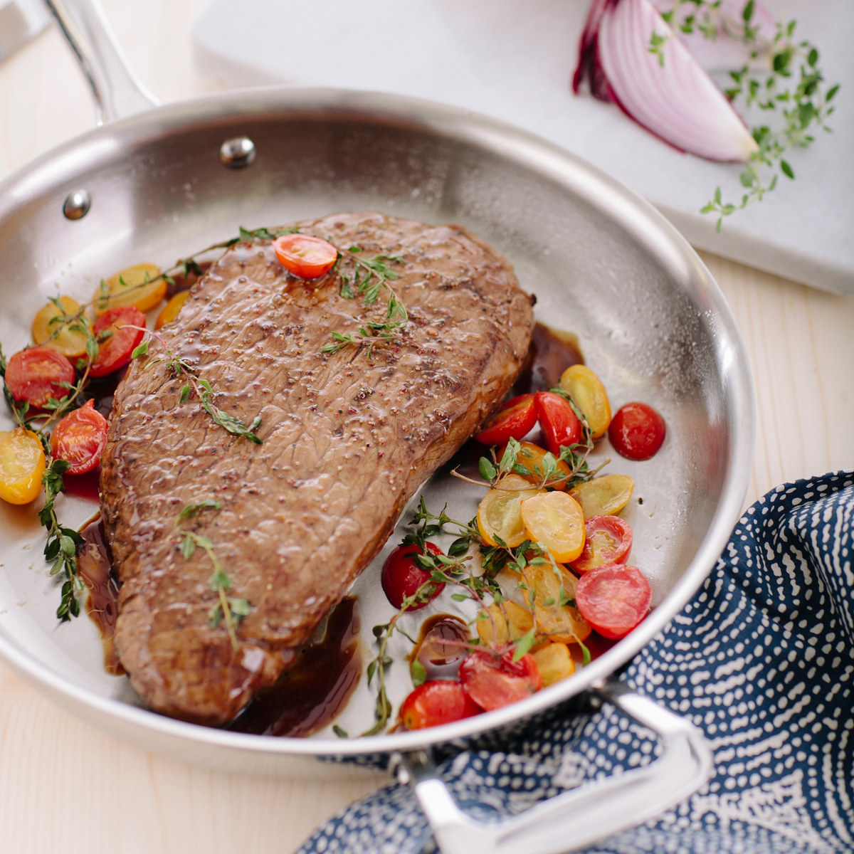 Steak with vegetables in a pan on a table